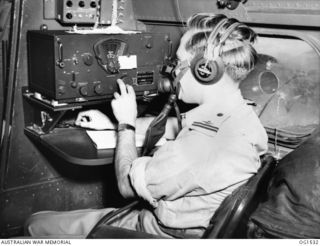 AIRBORNE OVER NEW GUINEA. C. 1944-08. 411453 FLYING OFFICER R. G. KELLOW, NEWCASTLE, NSW, WIRELESS AIR GUNNER, WHO JOINED NO. 37 (LOCKHEED LODESTAR) SQUADRON RAAF ON RETURN FROM ENGLAND, HAS HAD ..