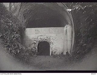 RABAUL, NEW BRITAIN. C.1945. A CONCRETE BUNKER FOR TORPEDO STOWAGE CONSTRUCTED IN A CAVE BY THE JAPANESE. (NAVAL HISTORICAL COLLECTION)