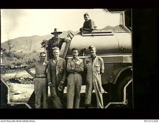 Ward's Airfield, Port Moresby, Papua. 1942. Informal group portrait of ground crew of No. 30 Squadron RAAF beside a refuelling tanker on the strip. Left to right: on tanker: Sergeant Wally Bell, ..
