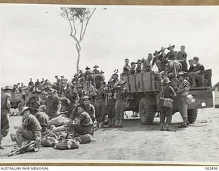 PORT MORESBY, PAPUA, NEW GUINEA. 1944-01-05. TROOPS OF THE 58/59TH AUSTRALIAN INFANTRY BATTALION, 15TH AUSTRALIAN INFANTRY BRIGADE, EMBUSSING PRIOR TO THEIR TRIP TO THE LANDING STRIP FOR THE ..