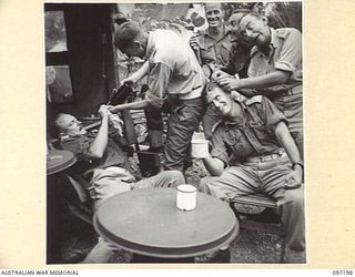 CAPE WOM, NEW GUINEA. 1945-09-27. A PICTURE REQUESTED BY LIEUTENANT COLONEL C. H. SELBY, COMMANDING OFFICER 2/7 FIELD AMBULANCE, SHOWING HIS OFFICERS "AFFECTED" BY BEING TOO LONG IN THE TROPICS