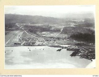 LAE, NEW GUINEA. 1944-03-30. VIEWING THE PORT AT LAE WITH THE NADZAB ROAD, AND THE LAE AIRSTRIP ON THE LEFT