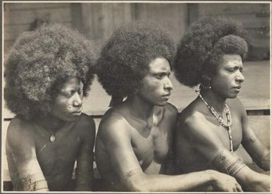 Mekeo types, Village Bioto [three men looking in same direction] / Frank Hurley