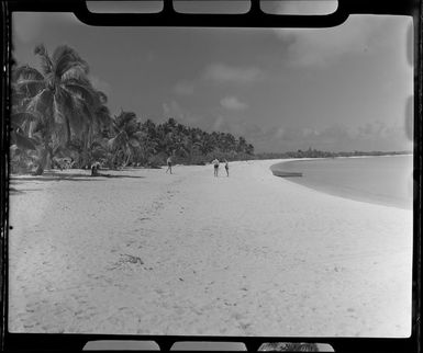 Tourists on beach, Akaiami, Aitutaki, Cook Islands, showing white sands and palm trees