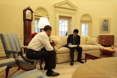 Barack Obama makes a phone call in the Oval Office