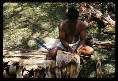 Man threading pandanus leaves, Mangaia, Cook Islands