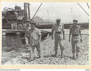 RABAUL, NEW BRITAIN. 1945-10-27. GENERAL SIR THOMAS A. BLAMEY, COMMANDER-IN-CHIEF, ALLIED LAND FORCES, SOUTH WEST PACIFIC AREA (2), AND MEMBERS OF THE OFFICIAL PARTY LEAVING BURNS PHILP WHARF. ..
