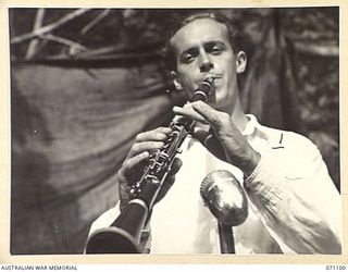 KILIGIA, NEW GUINEA. 1944-03-13. NX98782 SERGEANT H. DARGIE, WITH CLARINET, REHEARSING WITH THE 3RD ARMOURED DIVISION CONCERT PARTY. THE CONCERT PARTY IS AT PRESENT ENTERTAINING TROOPS OF THE 5TH ..