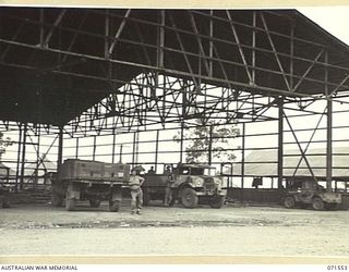 LAE, NEW GUINEA. 1944-03-23. THE HANGAR ALONGSIDE THE LAE AIRSTRIP WITHIN HEADQUARTERS, LAE BASE SUB AREAS, RE-BUILT AND IN OPERATION FOLLOWING BOMB DAMAGE RECEIVED FROM THE ROYAL AUSTRALIAN AIR ..