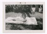 Baby laying on blanket outside