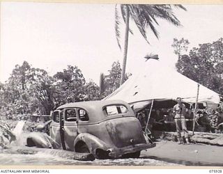 HANSA BAY, NEW GUINEA. 1944-09-07. Q22619 PRIVATE F.G. THORPE, MEDICAL ORDERLY, STANDING OUTSIDE THE TENT HOUSING THE UNIT REGIMENTAL AID POST OF C COMPANY, 25TH INFANTRY BATTALION ON THE BEACH ..