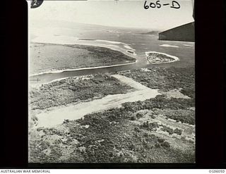 BUKA ISLAND, SOLOMON ISLANDS, NEW GUINEA. C. 1944. AERIAL VIEW OF BUKA AIR FIELD WITH NORTH SOLOMONS. LOOKING ACROSS BUKA STRAIT SOUTH SOUTH-WEST DOWN THE WEST COAST OF BOUGAINVILLE