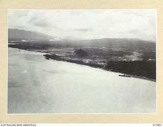 LAE, NEW GUINEA. 1944-03-30. AN AERIAL VIEW SHOWING THE BUTIBUM RIVER (FOREGROUND), AND THE MARKHAM RIVER (LEFT BACKGROUND) ENTERING THE SEA