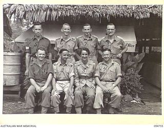 LAE AREA, NEW GUINEA, 1945-08-08. MEMBERS OF ARMY AUDIT STAFF, FIRST AUSTRALIAN ARMY. IDENTIFIED PERSONNEL ARE:- DRIVER A.R. LLOYD (1); MAJOR R.R. BALFE (2); CORPORAL L. LOBB (3); WARRANT OFFICER 1 ..