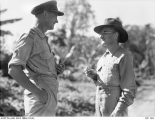 TOROKINA, BOUGAINVILLE. 1945-04-19. FATHER A. MULLER, A CATHOLIC PRIEST OF THE MARIST ORDER (2), WITH THE RED CROSS REPRESENTATIVE AT 2/1 GENERAL HOSPITAL. FATHER MULLER SPENT MANY MONTHS IN ..