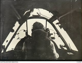 BISMARCK ARCHIPELAGO. 1944-03-28. FLIGHT SERGEANT T. BOEHM OF SA (REAR VIEW), THE PILOT OF A BEAUFIGHTER AIRCRAFT OF NO. 30 SQUADRON RAAF IN FLIGHT AS ESCORT FOR AIRCRAFT OF NO. 79 (SPITFIRE) ..