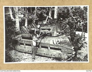 HUON PENINSULA AREA, NEW GUINEA. 1944-01-08. PERSONNEL OF "A" SQUADRON, 1ST AUSTRALIAN TANK BATTALION DOING MAINTENANCE WORK ON A MATILDA TANK IN THE WORKSHOP AREA OF THE 209TH LIGHT AID ..