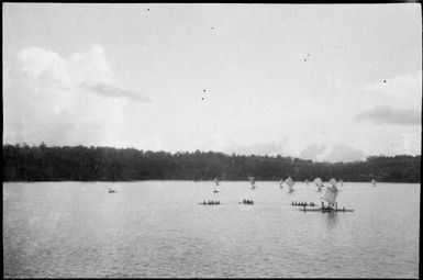 Three paddled canoes, and several canoes with sails, Lorengau, Manus Island, New Guinea, 1935 / Sarah Chinnery