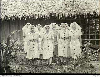 MILNE BAY, PAPUA. C. 1944-02. GROUP PORTRAIT OF RAAF NURSING SISTERS ON THE VERANDAH OF NO. 2 MEDICAL CLEARING STATION RAAF. LEFT TO RIGHT: SISTERS T. DUMOULIN, QLD; G. MCALLISTER, NSW; F. PARSONS, ..