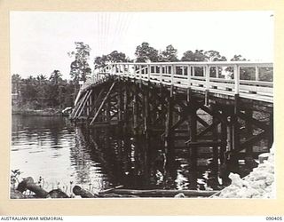 JACQUINOT BAY, NEW BRITAIN. 1945-04-08. A CLASS 9 PILE BRIDGE BUILT OVER THE KALUMALAGI RIVER BY 35 FIELD COMPANY, ROYAL AUSTRALIAN ENGINEERS. IT IS 315 FEET LONG WITH 19 SPANS, EACH OF 15 FEET. A ..