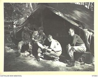 KELANOA, NEW GUINEA, 1944-02-21. PATIENTS AND STAFF AT THE REGIMENTAL AID POST, 5TH AUSTRALIAN DIVISION HEADQUARTERS. IDENTIFIED PERSONNEL ARE: SX16545 LANCE-CORPORAL E.G. SMITH (1); Q100403 ..