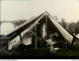 Port Moresby, Papua. 1941-12. Interior of a hospital tent at No. 5 Casualty Clearing Station. Note the surgical gowns hanging on a line inside the tent and the piles of linen on tables. (Original ..