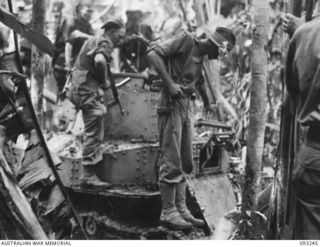 CHABAI/SORAKEN AREA, BOUGAINVILLE, 1945-06-16. BRIG J.R. STEVENSON, COMMANDER 11 INFANTRY BRIGADE, INSPECTING A TYPE 89 TANK FOUND BY C COMPANY, 26 INFANTRY BATTALION (AIF).The Battalion war diary ..