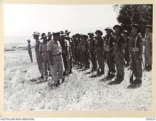 LAE AREA, NEW GUINEA. 1945-09-01. COLONEL J.T. SIMPSON, DEPUTY DIRECTOR OF ORDNANCE SERVICE INSPECTING 7 PLATOON DURING A PARADE OF THE ORDNANCE PERSONNEL UNDER HIS COMMAND IN THE LAE AREA. THE ..