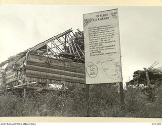 FINSCHHAFEN AREA, NEW GUINEA, 1944-03-18. ONE OF MANY BATTLE SIGNS IN THE FINSCHHAFEN AREA, THIS SIGN, IN THE VILLAGE OF KUANKO, RECORDS ACTIVITIES OF THE 2/23RD INFANTRY BATTALION, AND OF ..