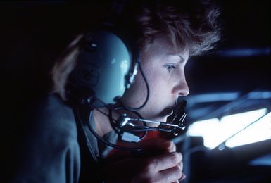 AIRMAN 1ST Class Angela Owens, the boom operator aboard a 41st Air Refueling squadron KC-135 Stratotanker aircraft, keeps a close eye on an aircraft that is receiving fuel during exercise Giant Warrior '89. The Stratotanker is operating from Anderson Air Force Base, Guam