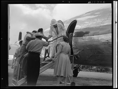 Patient being assisted aboard an aircraft, Rarotonga, Cook Islands