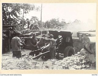 SORAKEN, BOUGAINVILLE. 1945-06-05. NO. 1 GUN, C TROOP, 11 BATTERY, 4 FIELD REGIMENT ENGAGING A TARGET ON COMMO RIDGE. IDENTIFIED PERSONNEL ARE:- SERGEANT T.G. BROOKES (1); GUNNER T.C. FEEBY (2); ..