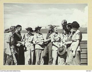 LAE, NEW GUINEA, 1945-05-07. A GROUP OF AUSTRALIAN WOMEN'S ARMY SERVICE AND TROOPS WHO TRAVELLED FROM AUSTRALIA TOGETHER ON THE MV DUNTROON, SAYING GOODBYE BEFORE DISEMBARKATION. THE AUSTRALIAN ..
