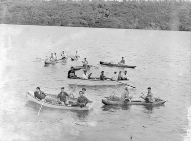 [Men in canoes and rowboats]