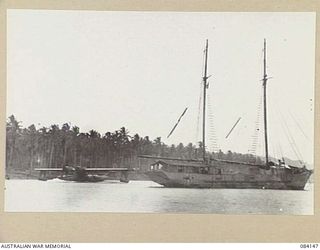 JACQUINOT BAY, NEW BRITAIN. 1944-12-04. AN RAAF CATALINA FLYING BOAT TAXIING FROM THE BAY, PASSES THE WATER TRANSPORT AUXILIARY KETCH AK 94