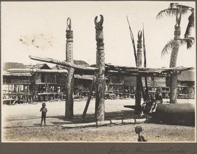 Dubu, Hanuabada [village scene showing four carved wooden poles supporting a platform] Frank Hurley