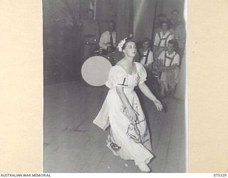 LAE, NEW GUINEA. 1944-08-17. TFX6011 CAPTAIN T.G. SECRETAN, PHYSIOTHERAPIST, 2/7TH GENERAL HOSPITAL DANCING DURING THE SHOW STAGED BY THE WHITE HORSE INN CONCERT PARTY AT HEADQUARTERS, NEW GUINEA ..