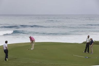 Barack Obama plays golf with Prime Minister Najib Razak, Joe Paulsen, and Mike Brush in Kaneohe Bay, Hawaii, December 24, 2014