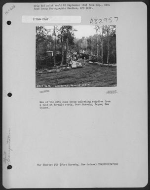 Men of the 38th Bomb Group unloading supplies from a boat at 30-mile strip, Port Moresby, Papua, New Guinea. (U.S. Air Force Number 117684AC)