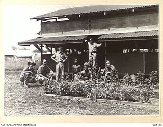 LAE AREA, NEW GUINEA. 1944-12-20. SENIOR REPRESENTATIVE GREEN, (6), OUTSIDE THE YMCA HUT WITH HIS STAFF OF WILLING HELPERS. IDENTIFIED PERSONNEL ARE:- PRIVATE C A CONSTABLE, (1); PTE E R TOZER, ..
