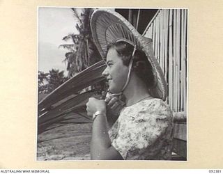 MOROTAI, 1945-05-17. LIEUTENANT J. RICHARDSON, AUSTRALIAN ARMY NURSING SERVICE, 66 CAMP HOSPITAL, WEARING A COOLIE HAT, A SOUVENIR OF THE PACIFIC ISLANDS