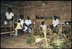 Men with divding wrapped food for feast