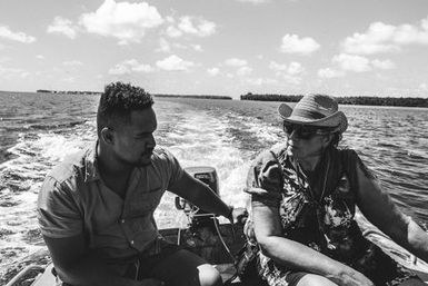 Grace Hutton Collection Manager Pacific Cultures at Te Papa with co-collector Le Naponita Lepaio (Poni) steering an aluminium dinghy, Atafu, Tokelau