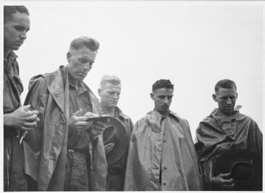 Father English conducts a burial service for three NCOs from the 2/3rd Australian Independent Company, Orodubi, New Guinea, 30 July, 1943