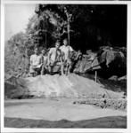 Four workmen (Roma, Tenii, Kamio, Dani) and Expedition (explorers club flag) in Te Ana Pu, Aukena