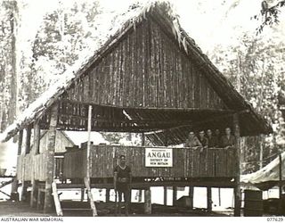 KAMALGAMAN ANCHORAGE, JACQUINOT BAY, NEW BRITAIN. 1944-12-23. THE CLERICAL STAFF AND A NATIVE ORDERLY AT THE ADMINISTRATION HEADQUARTERS, AUSTRALIAN NEW GUINEA ADMINISTRATIVE UNIT, NEW BRITAIN ..