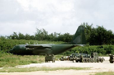 Air Force personnel prepare to board the last C-130 Hercules aircraft back to Guam, after four days of directing other C-130s in and offloading them for the Navy seabees, who will stay to participate in Exercise Kennel Bear '4-82