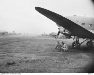 DUMPU, NEW GUINEA. 1944-01-08. THE AIRSTRIP WITH APPROXIMATELY 36 DOUGLAS TRANSPORT PLANES ON EACH SIDE OF THE TAXIING STRIP. THE PLANES HAD JUST ARRIVED FROM PORT MORESBY WITH UNITS OF 15TH ..
