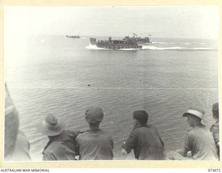 NAGADA, NEW GUINEA. 1944-05-31. AMERICAN LANDING BARGES CONVEY MEMBER OF THE 37/52ND INFANTRY BATTALION TO SARANG HARBOUR A FORWARD BASE IN PREPARATIONS FOR A BEACH LANDING ON KARKAR ISLAND