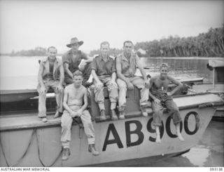 SORAKEN AREA, BOUGAINVILLE, 1945-06-12. THE CREW OF ALC900, MEMBERS OF THE NORTHERN DETACHMENT OF 42 LANDING CRAFT COMPANY, WHICH WAS STRANDED ON A REEF FOR 6 1/2 HOURS, 30 YARDS FROM THE SHORE AND ..